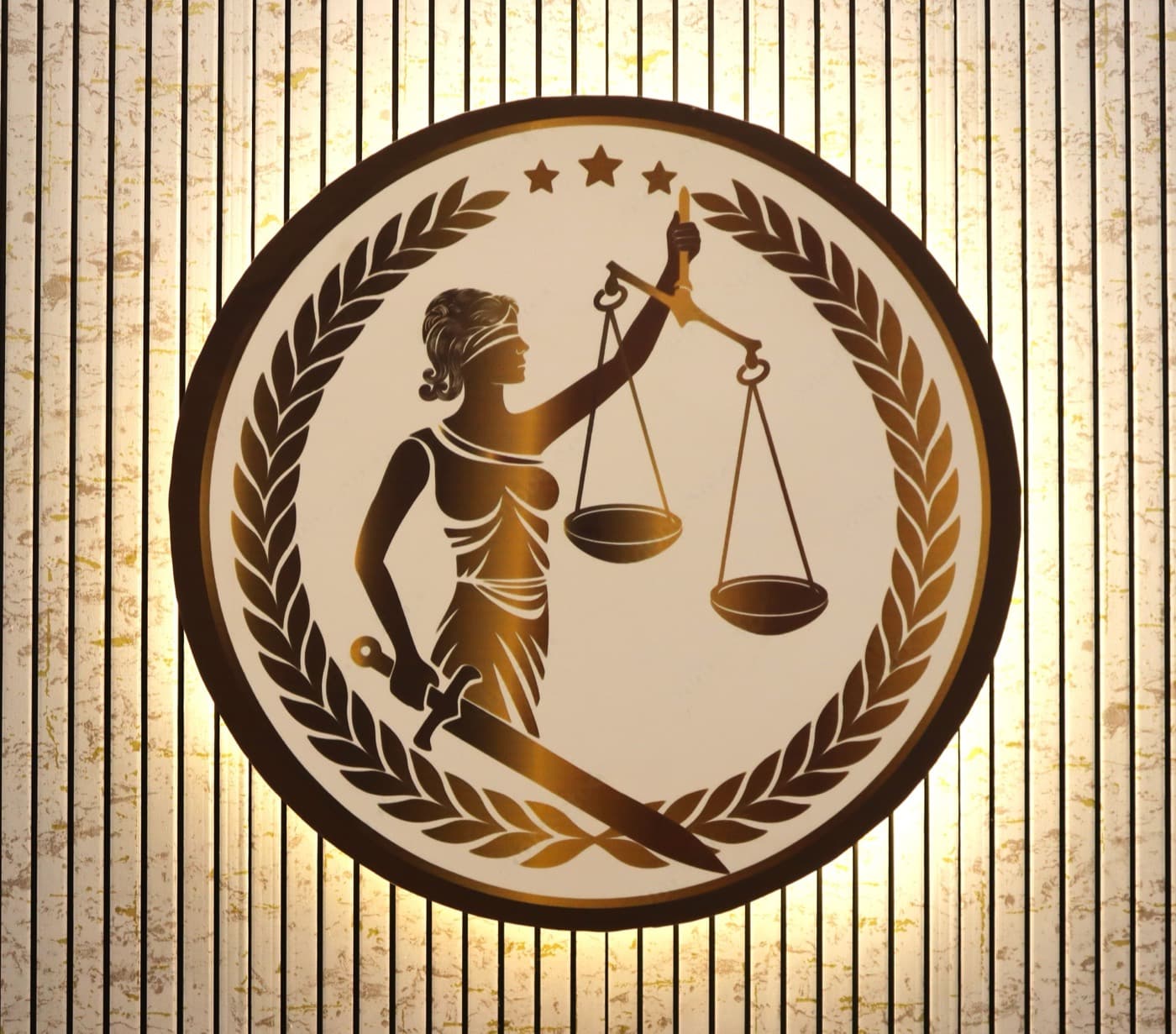 The Lady Justice emblem on the chamber wall